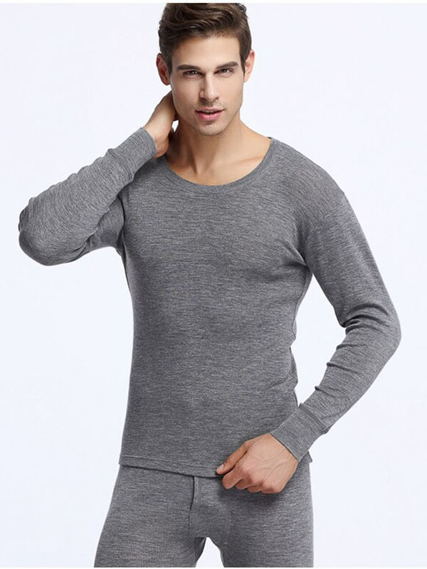 Model wearing gray men's 100% merino wool thermal underwear set - warm and comfortable, perfect for outdoor winter activities.